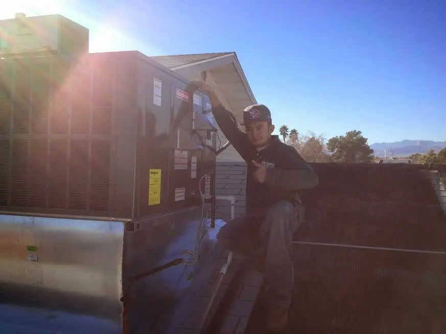 HVAC technician performing HVAC Inspection on a rooftop unit in Hammonton
